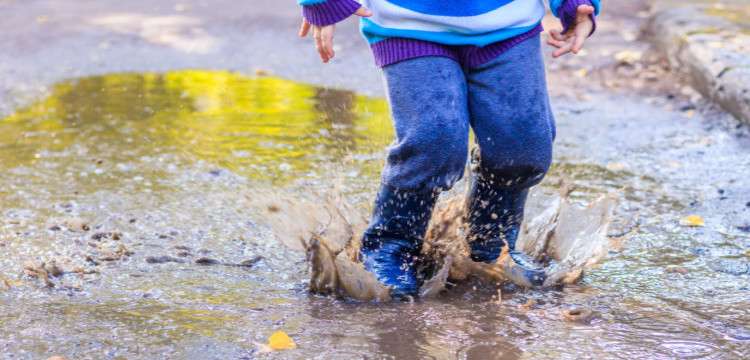 Kid Playing In A Puddle